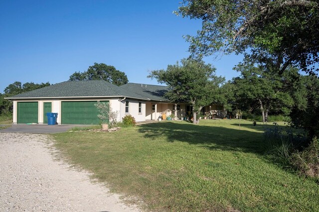 view of front facade with a front lawn and a garage