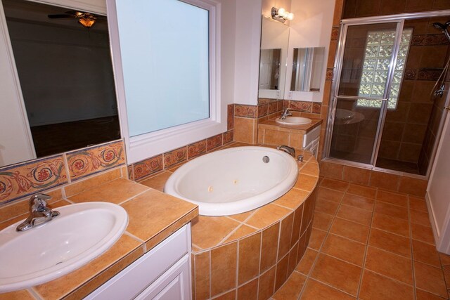 bathroom with vanity, tile patterned floors, and shower with separate bathtub