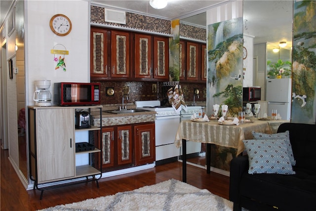 kitchen with tasteful backsplash, sink, white appliances, and dark hardwood / wood-style floors