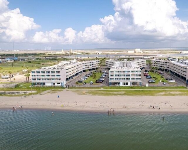 birds eye view of property featuring a beach view and a water view