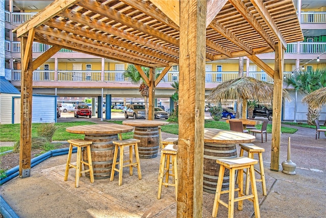 view of patio / terrace with an outdoor bar and a balcony