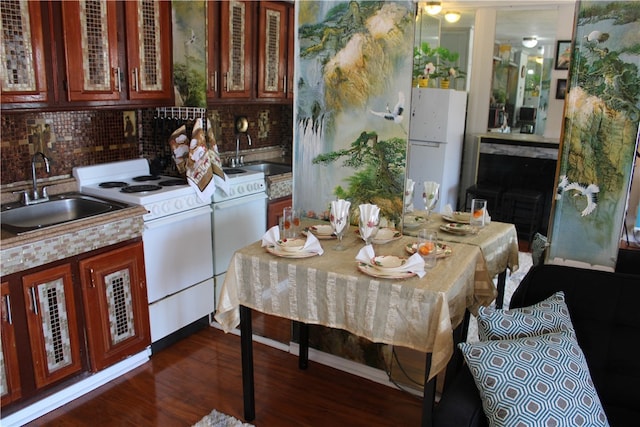 dining space with dark hardwood / wood-style flooring and sink