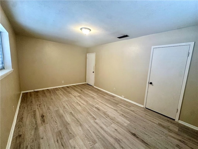 5226 Honeysuckle, Corpus Christi, TX 78415 - empty room with baseboards, visible vents, and wood finished floors