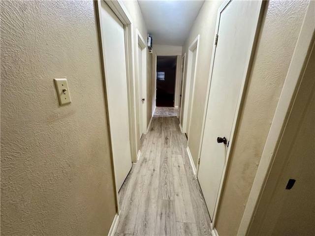 5226 Honeysuckle, Corpus Christi, TX 78415 - hallway with light wood-style flooring, baseboards, and a textured wall