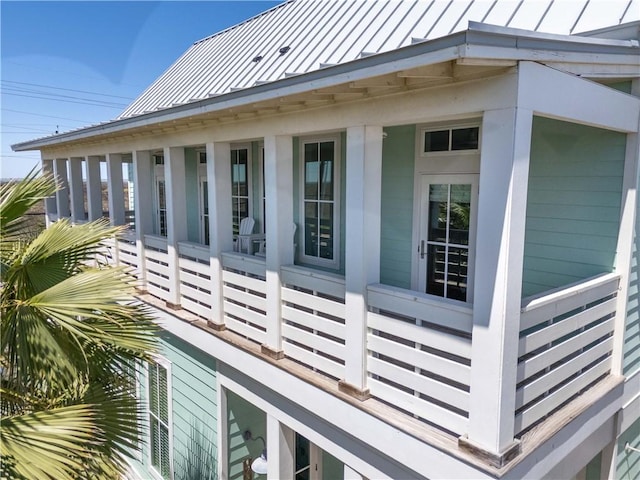 125 Fish Hook Ln, Port Aransas, TX 78373 - view of side of property featuring a porch and a standing seam roof
