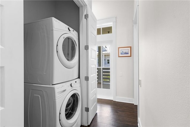125 Fish Hook Ln, Port Aransas, TX 78373 - laundry room featuring baseboards, stacked washer / dryer, dark wood-type flooring, and laundry area