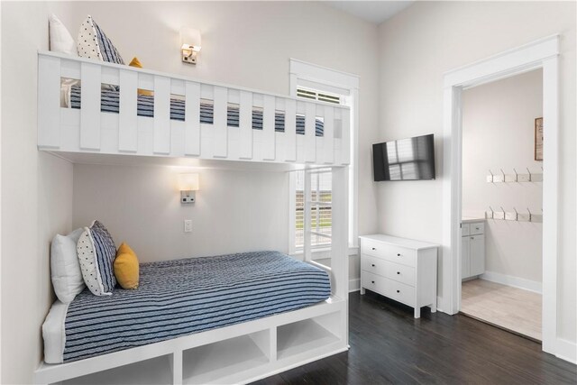 125 Fish Hook Ln, Port Aransas, TX 78373 - bedroom with baseboards and dark wood-style flooring
