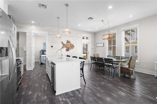 125 Fish Hook Ln, Port Aransas, TX 78373 - kitchen featuring dark wood-style flooring, baseboards, visible vents, light countertops, and appliances with stainless steel finishes