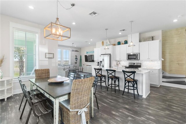 125 Fish Hook Ln, Port Aransas, TX 78373 - dining space featuring dark wood-style flooring, a notable chandelier, visible vents, and recessed lighting