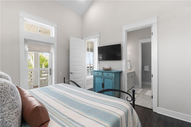 125 Fish Hook Ln, Port Aransas, TX 78373 - bedroom featuring ensuite bathroom, baseboards, high vaulted ceiling, and dark wood finished floors
