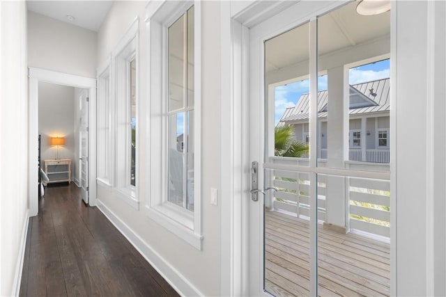 125 Fish Hook Ln, Port Aransas, TX 78373 - doorway to outside featuring baseboards and dark wood-type flooring