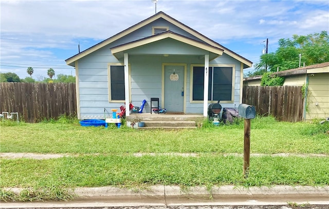 bungalow-style home featuring a front lawn