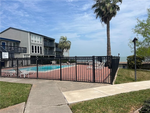 community pool featuring fence