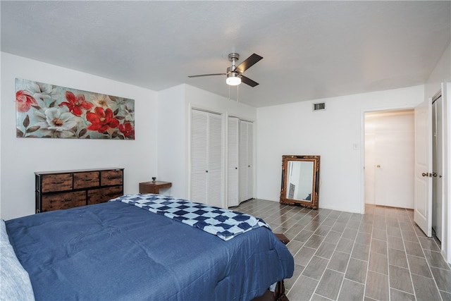 bedroom with two closets and ceiling fan