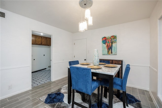 dining area featuring dark wood-type flooring