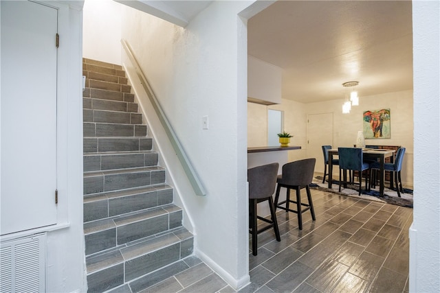 stairway with an inviting chandelier