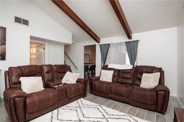 living room featuring beamed ceiling and high vaulted ceiling