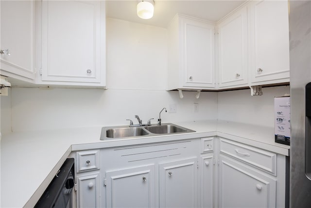 kitchen featuring white cabinetry, sink, and dishwashing machine