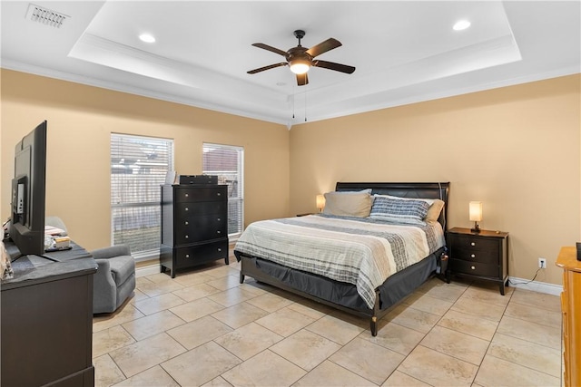 bedroom featuring a tray ceiling, visible vents, baseboards, and light tile patterned flooring