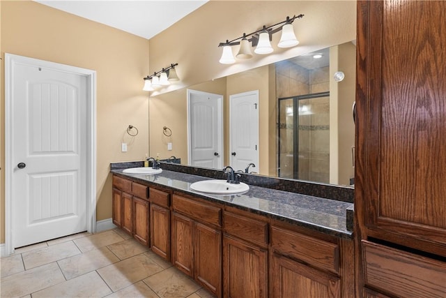 full bathroom featuring double vanity, a sink, and a shower stall