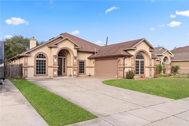 view of front of property with an attached garage, concrete driveway, stucco siding, a front lawn, and a chimney