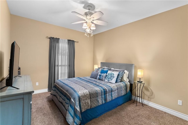 carpeted bedroom with a ceiling fan and baseboards