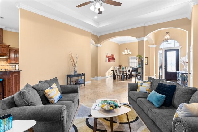 living room with light tile patterned floors, arched walkways, crown molding, and ornate columns