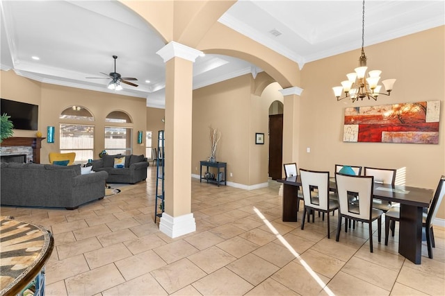 dining space with a ceiling fan, a tray ceiling, arched walkways, and baseboards