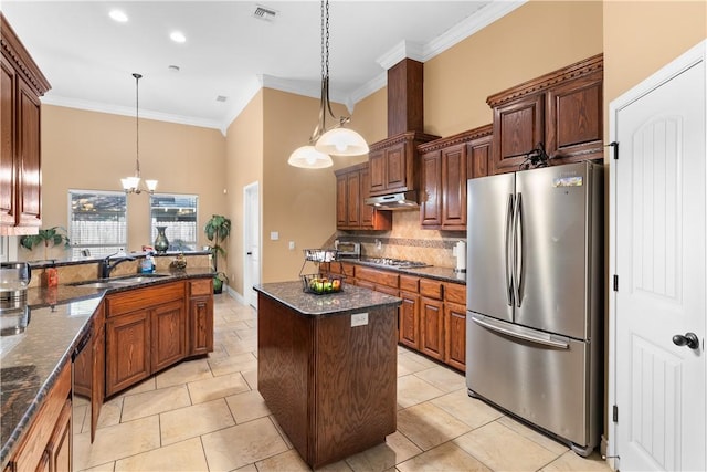 kitchen featuring a sink, visible vents, appliances with stainless steel finishes, decorative backsplash, and crown molding