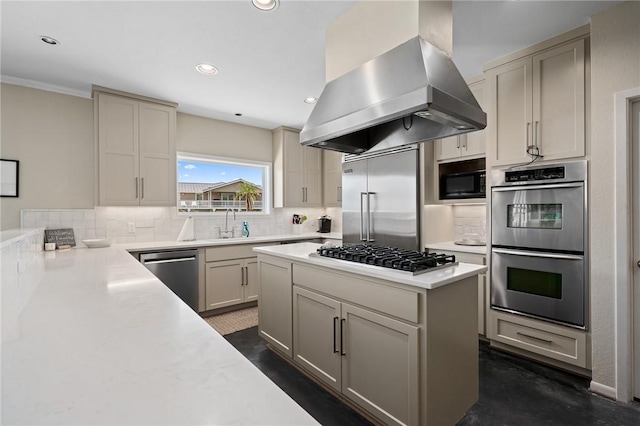 kitchen with sink, island range hood, built in appliances, and decorative backsplash