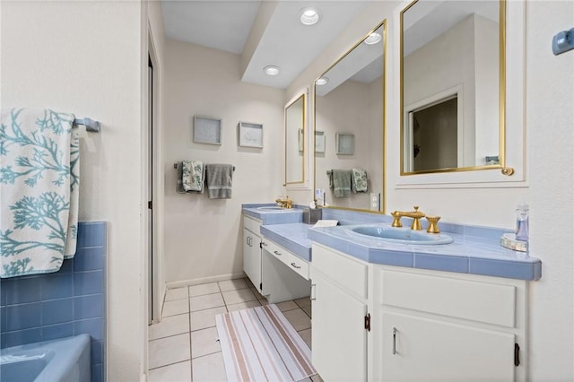 bathroom featuring vanity, tile patterned floors, and a tub to relax in