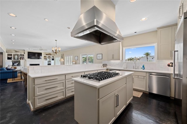 kitchen with sink, island range hood, kitchen peninsula, a kitchen island, and stainless steel appliances