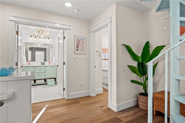 interior space with wood finished floors, vanity, and baseboards