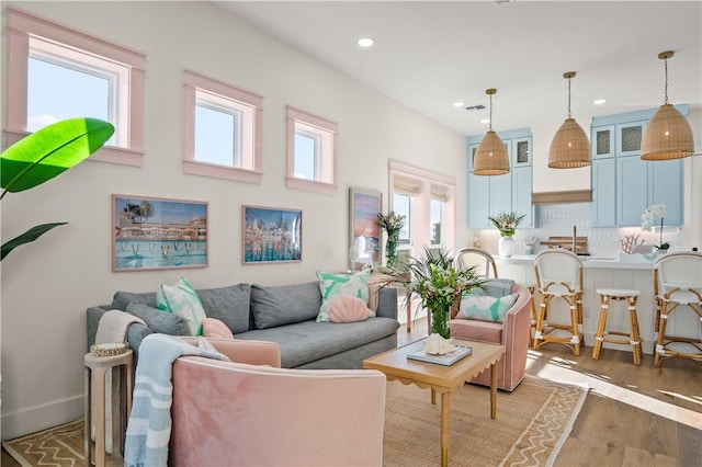 living room featuring recessed lighting, visible vents, and wood finished floors