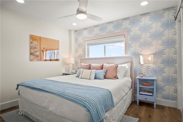 bedroom featuring baseboards, recessed lighting, wood finished floors, and wallpapered walls