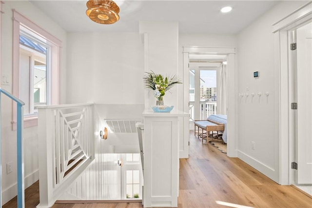 corridor featuring recessed lighting, light wood-type flooring, visible vents, and baseboards