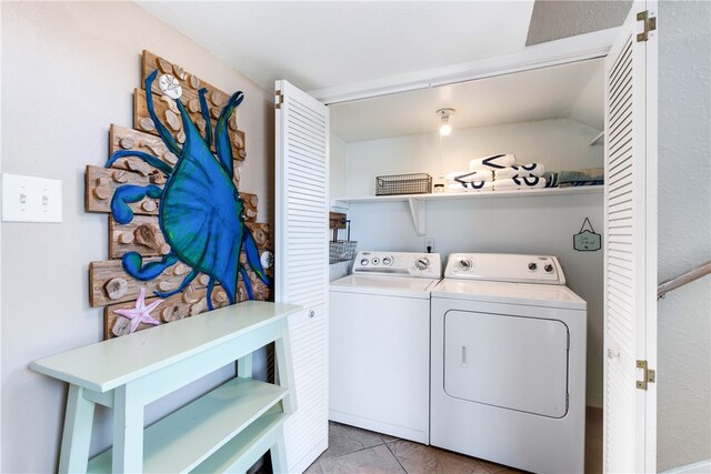 laundry room with light tile patterned floors and washing machine and clothes dryer