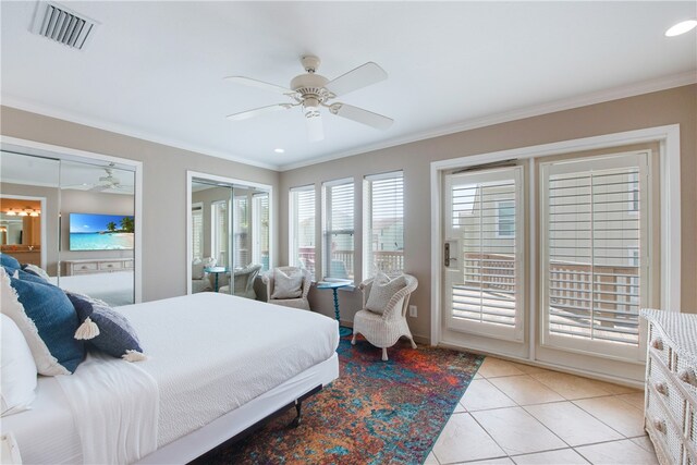 bedroom with multiple closets, light tile patterned floors, ceiling fan, and crown molding