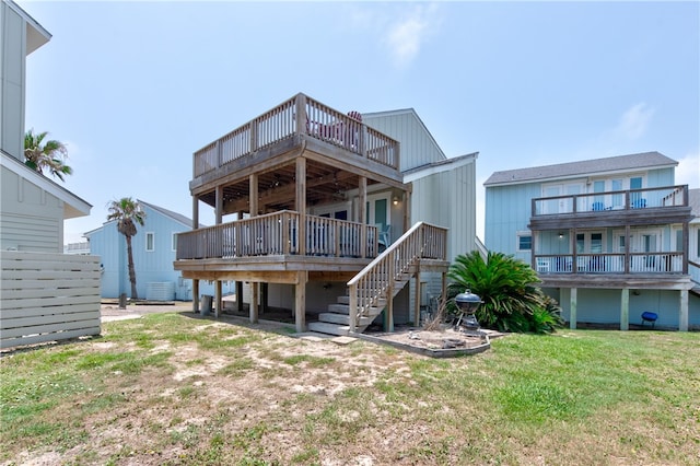 rear view of house with central AC unit, a yard, and a deck