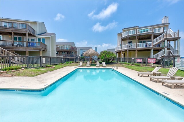 view of swimming pool featuring a patio area and a lawn