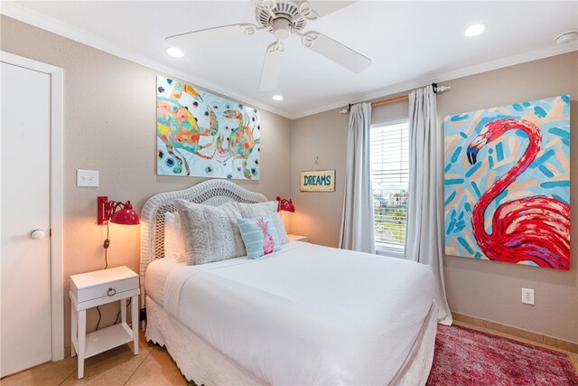 bedroom with ceiling fan, light tile patterned floors, and ornamental molding