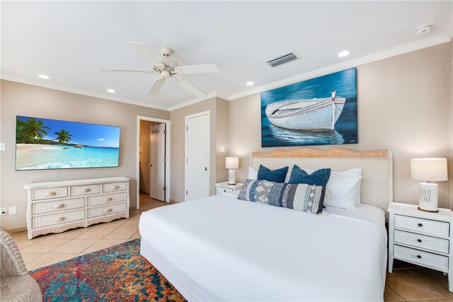 tiled bedroom with ceiling fan and crown molding