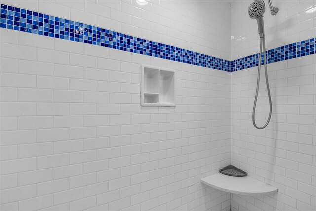 bathroom with a tile shower