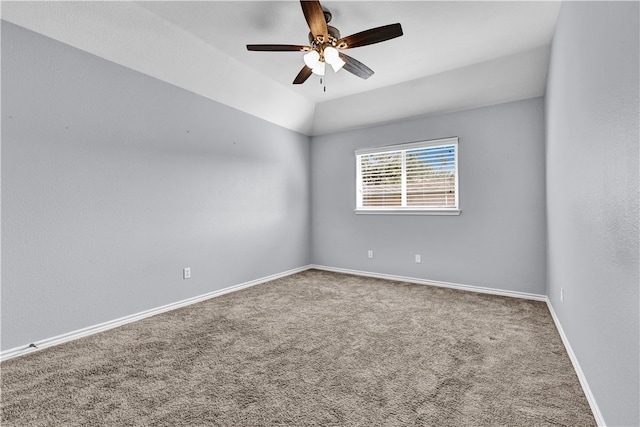 spare room featuring carpet floors, ceiling fan, and vaulted ceiling