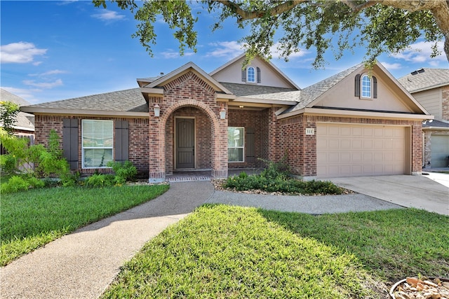 view of front of house featuring a garage and a front lawn