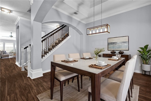 dining room featuring dark hardwood / wood-style flooring, ornamental molding, and ceiling fan