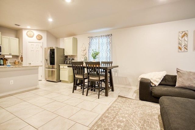 dining space with recessed lighting, light tile patterned floors, vaulted ceiling, baseboards, and visible vents