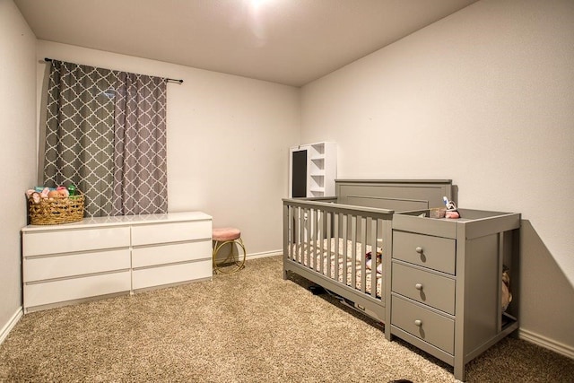 carpeted bedroom featuring baseboards