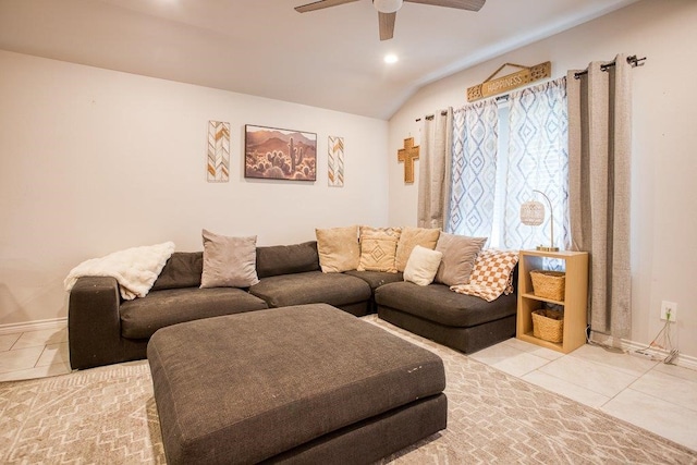 living area with tile patterned floors, ceiling fan, lofted ceiling, and baseboards