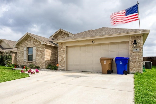 ranch-style home featuring a garage, brick siding, driveway, and roof with shingles